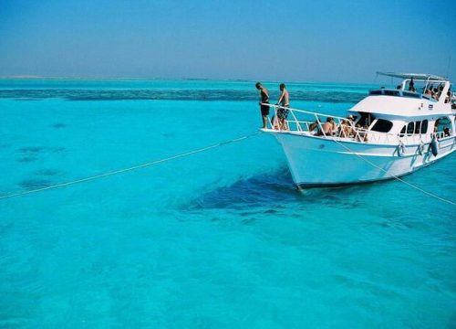 Boat anchored near Giftun Island with tourists swimming